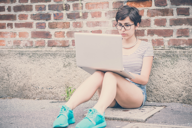 young hipster woman using notebook