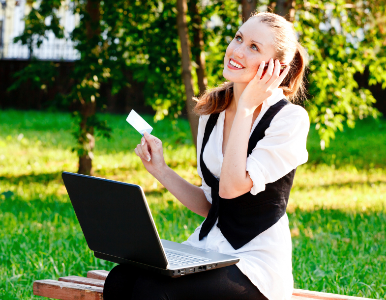 Beautiful Woman with Credit Card Using Her Laptop.