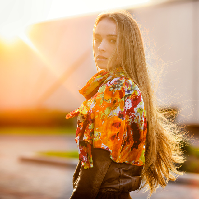 Beautiful caucasian woman walking on the road in autumn