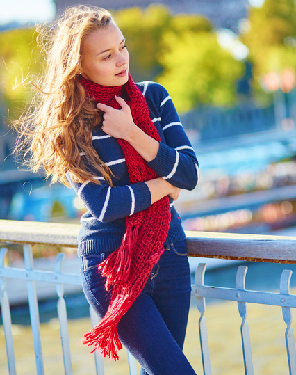 Beautiful girl in red scarf on a fall day in Paris