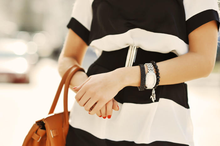 Fashionable woman with handbag in hands - close up