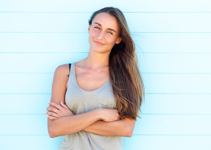 Young woman posing with arms crossed