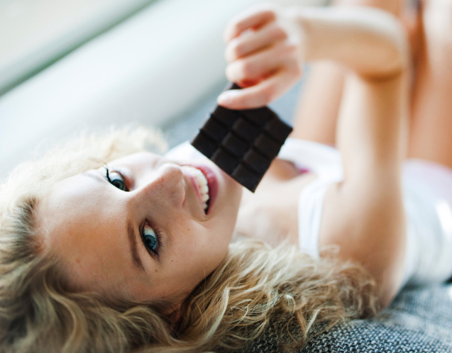 High angle portrait of woman having chocolate bar