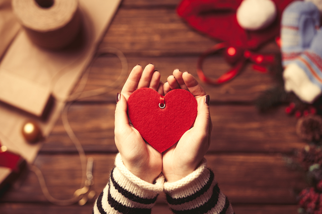 Woman holding a heart shape toy