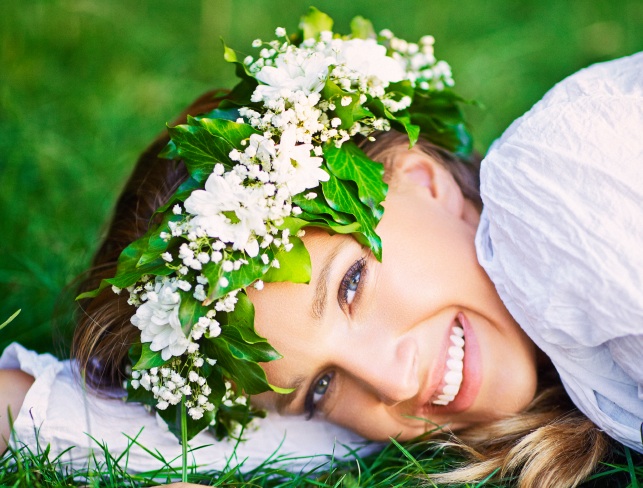 Beautiful smiling woman with a flower wreath on her head