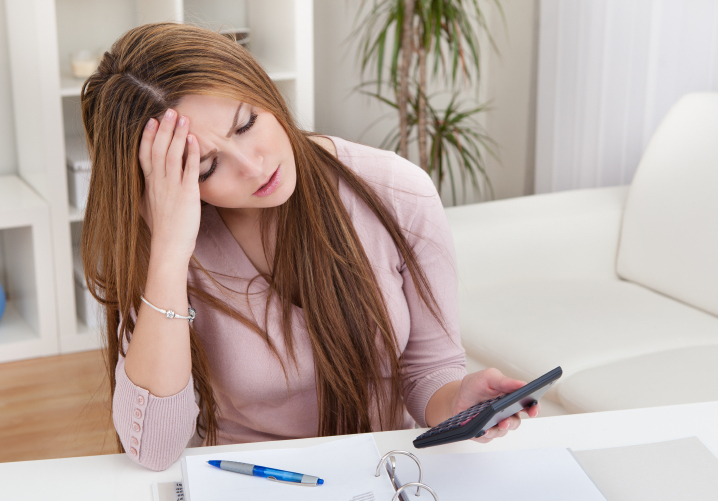 Young Woman Calculating Bills