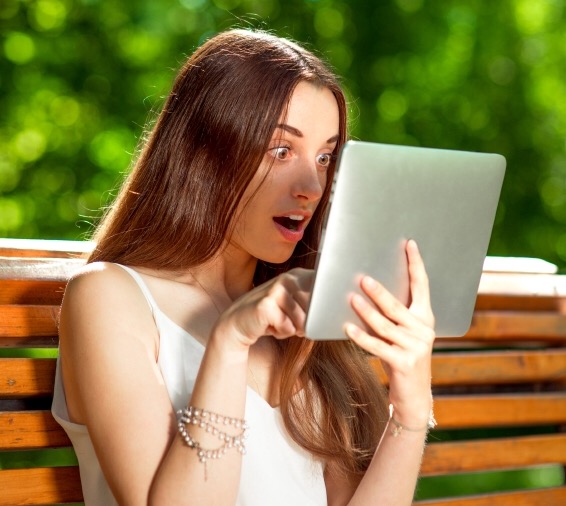 Young woman with digital tablet in the park