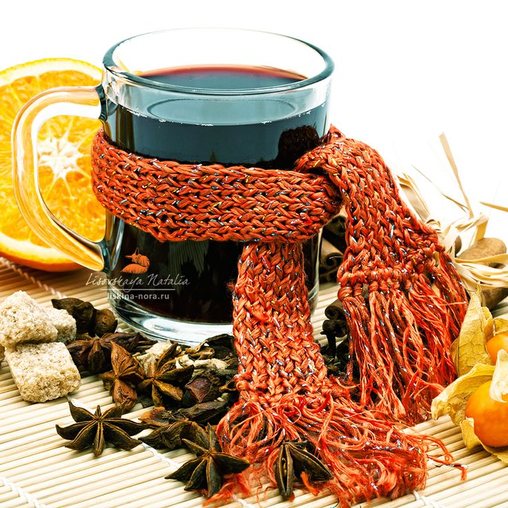 Cup of hot wine and spices on cane tray