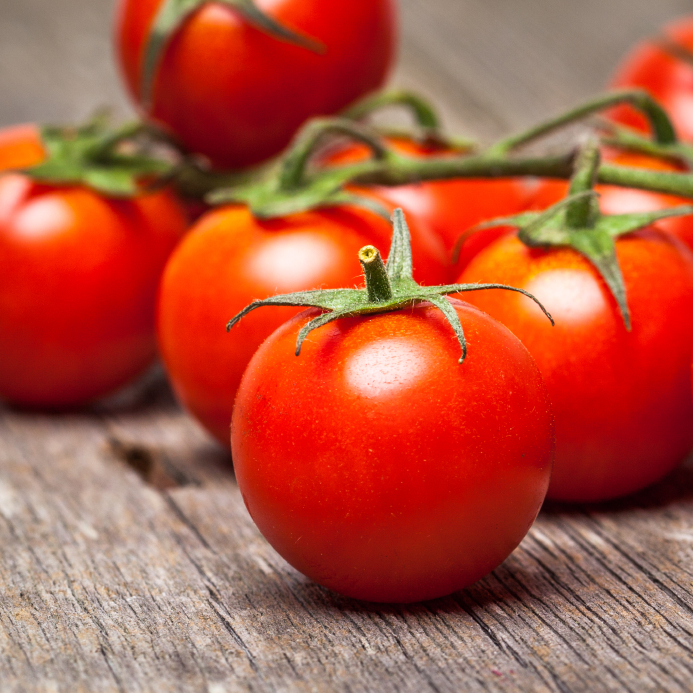 Close-up of fresh, ripe cherry tomatoes on wood