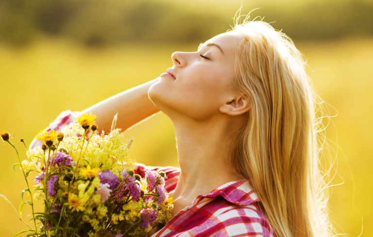 Happy girl with a bouquet of beautiful flowers